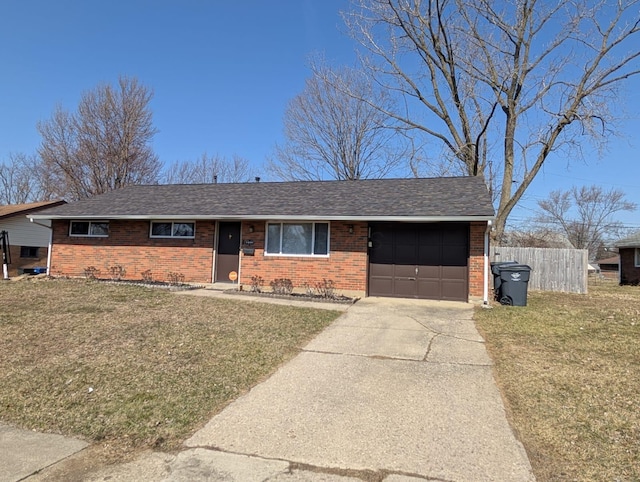 ranch-style house featuring brick siding, an attached garage, fence, a front yard, and driveway