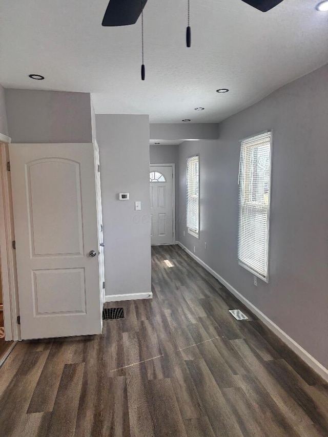 interior space with visible vents, wood finished floors, and baseboards