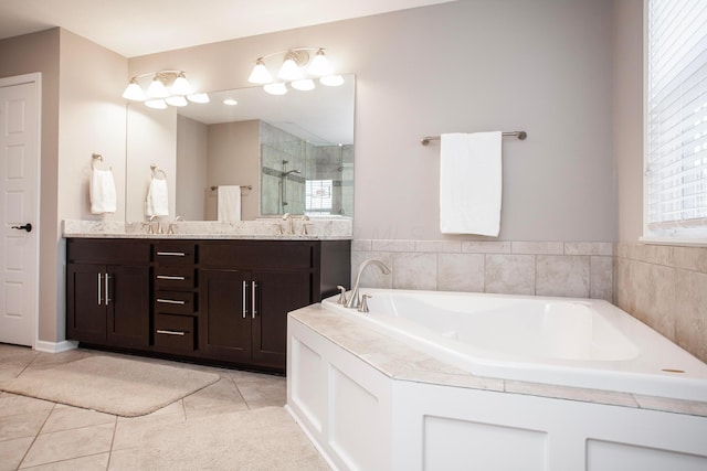 bathroom with tile patterned flooring, a shower stall, a garden tub, double vanity, and a sink