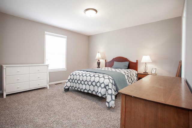 carpeted bedroom with baseboards and visible vents