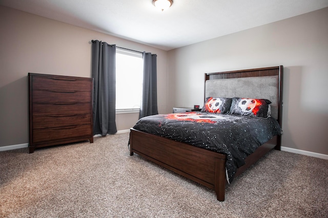 carpeted bedroom featuring baseboards