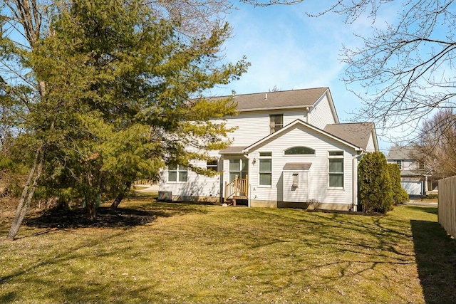 view of front of property featuring entry steps, a front lawn, and fence