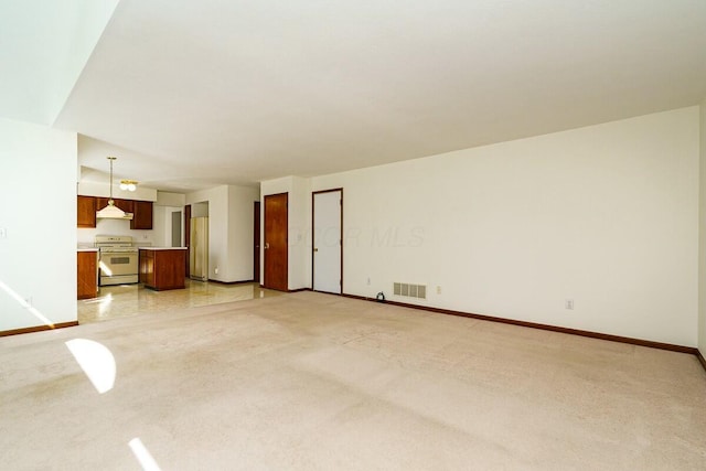 unfurnished living room featuring light colored carpet, baseboards, and visible vents