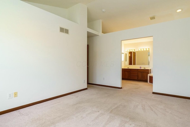 unfurnished bedroom with light carpet, visible vents, and baseboards