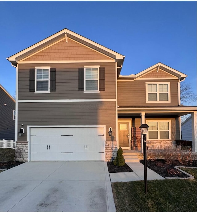 craftsman-style home with stone siding, covered porch, an attached garage, and concrete driveway