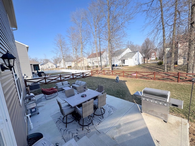 view of patio with outdoor dining space, a residential view, a fenced backyard, and area for grilling