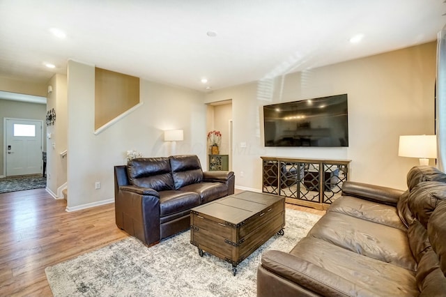 living room featuring recessed lighting, baseboards, and wood finished floors