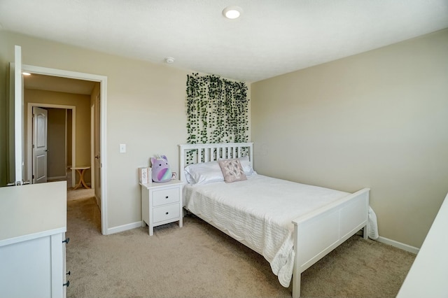 bedroom featuring baseboards and light colored carpet