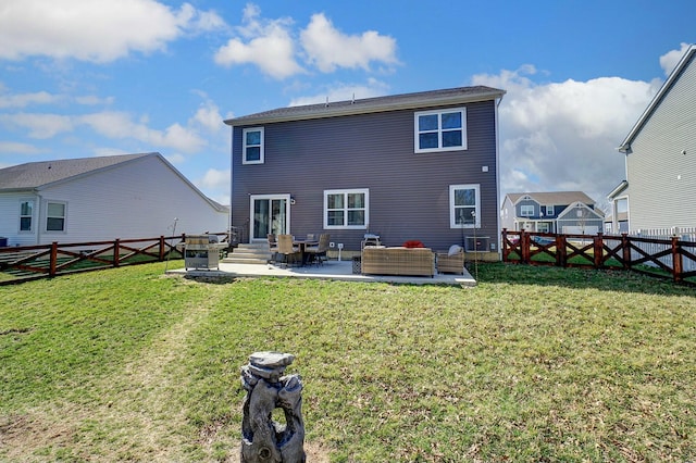 rear view of property featuring a fenced backyard, a patio area, a yard, and a gate