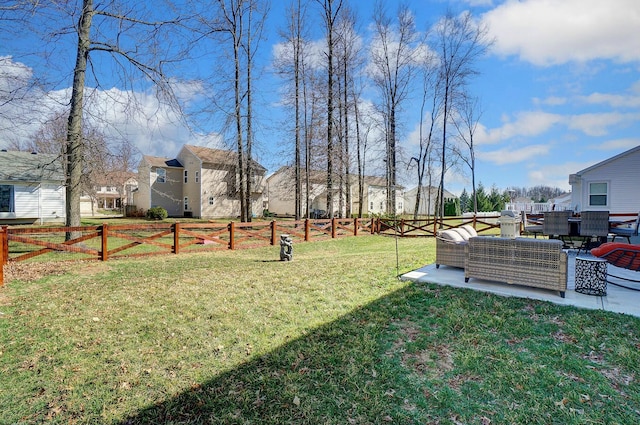 view of yard with a patio area, a fenced backyard, a residential view, and an outdoor living space