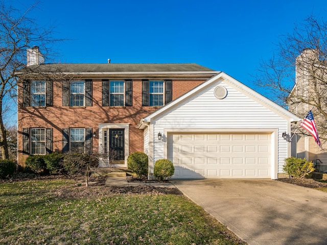 colonial home featuring brick siding, driveway, and an attached garage