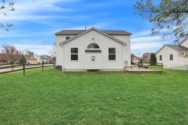 rear view of house with a yard, a patio, central AC, and fence