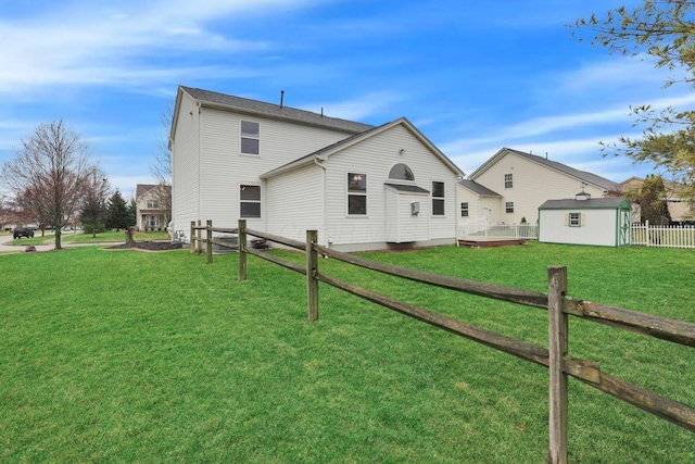 view of side of property with a yard, an outbuilding, a shed, and fence