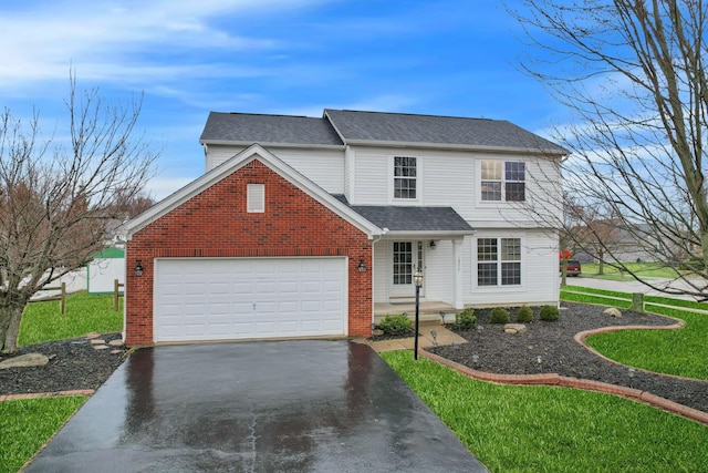 traditional-style house featuring brick siding, an attached garage, a shingled roof, a front yard, and driveway