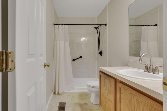 bathroom with tiled shower, toilet, vanity, and visible vents