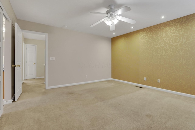 unfurnished room with baseboards, light carpet, a ceiling fan, and wallpapered walls