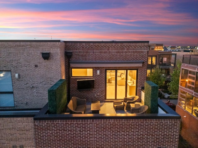 321 Auden Ave, Columbus, OH 43215 - back of house with an outdoor living space, brick siding, and a balcony
