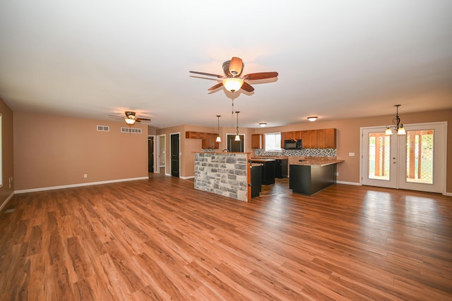 1025 Edison Ave, Marion, OH 43302 - unfurnished living room featuring a ceiling fan, healthy amount of natural light, and wood finished floors