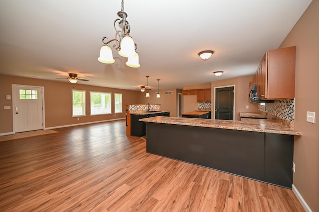 1025 Edison Ave, Marion, OH 43302 - kitchen with a peninsula, a ceiling fan, light wood-type flooring, and a chandelier