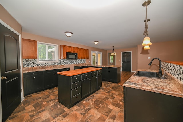 1025 Edison Ave, Marion, OH 43302 - kitchen featuring black microwave, a kitchen island, tasteful backsplash, and butcher block counters