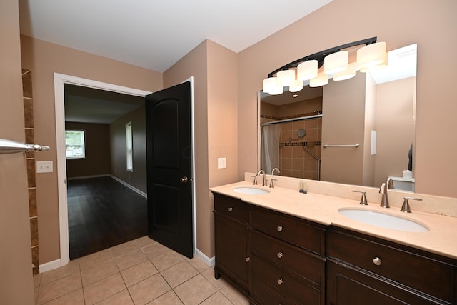 1025 Edison Ave, Marion, OH 43302 - bathroom with tiled shower, double vanity, and tile patterned flooring