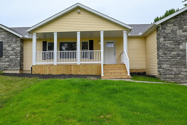1025 Edison Ave, Marion, OH 43302 - view of front facade featuring covered porch, stone siding, a shingled roof, and a front lawn