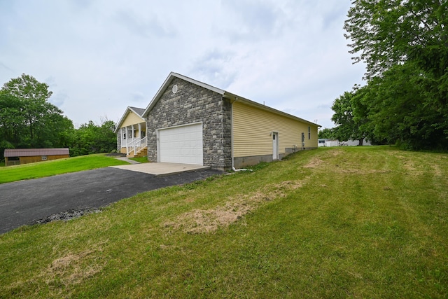 1025 Edison Ave, Marion, OH 43302 - view of side of home with stone siding, a yard, and a detached garage