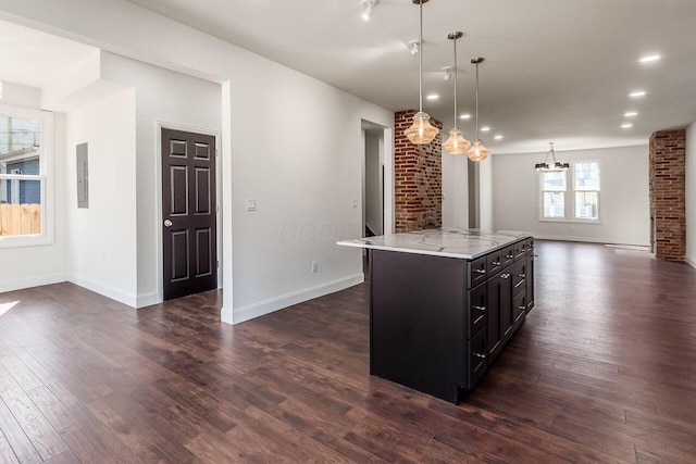 kitchen with dark wood finished floors, electric panel, decorative light fixtures, open floor plan, and a chandelier