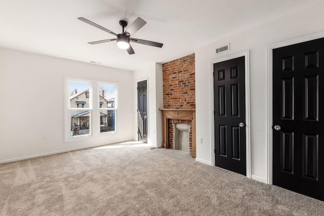 unfurnished living room featuring visible vents, carpet floors, and ceiling fan