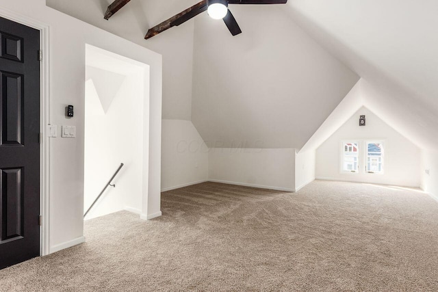 bonus room featuring baseboards, lofted ceiling with beams, a ceiling fan, and carpet floors