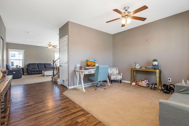 carpeted office with wood finished floors, baseboards, and ceiling fan