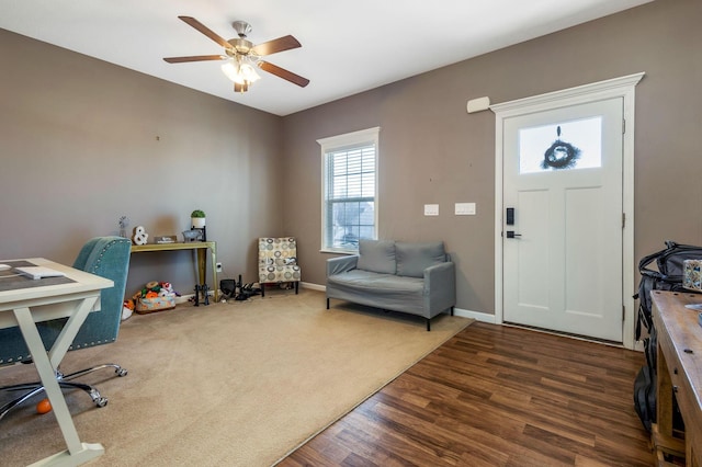 entryway featuring baseboards, wood finished floors, and a ceiling fan