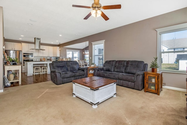 living room with ceiling fan, recessed lighting, baseboards, and light carpet