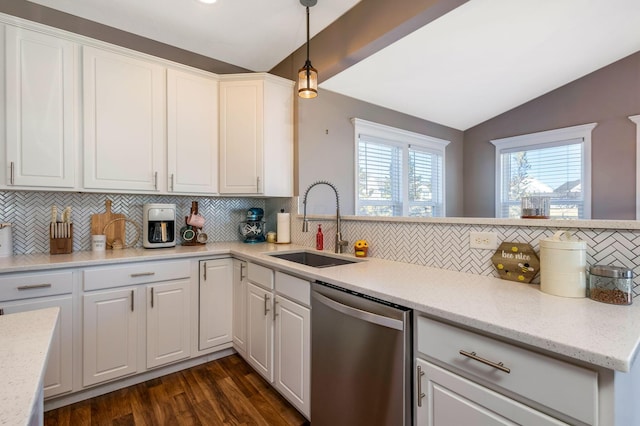 kitchen featuring dark wood-style floors, white cabinetry, a sink, vaulted ceiling, and stainless steel dishwasher