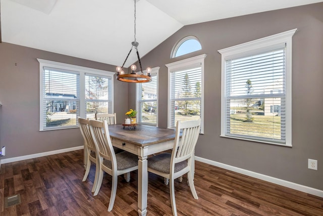 dining area featuring visible vents, baseboards, dark wood finished floors, a chandelier, and vaulted ceiling