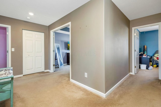 hallway with carpet and baseboards