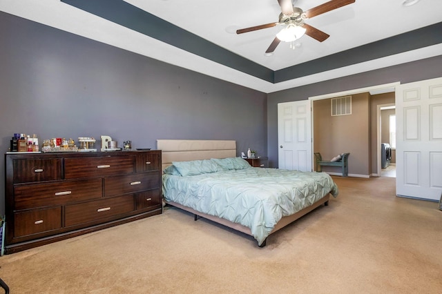 bedroom with visible vents, a ceiling fan, washer / clothes dryer, baseboards, and light colored carpet