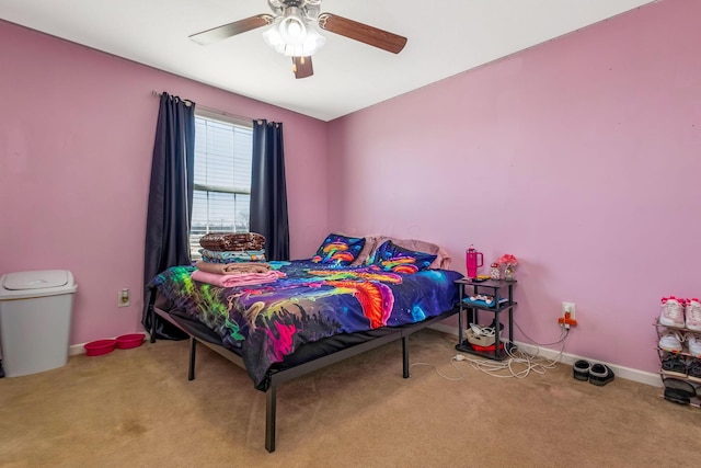 carpeted bedroom with ceiling fan and baseboards