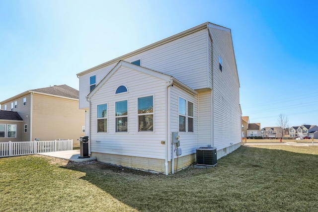 back of house featuring a yard, cooling unit, and fence