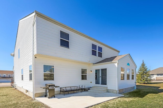 rear view of house featuring a patio area, a lawn, and entry steps