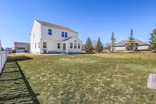 rear view of house featuring a yard, a patio area, and fence