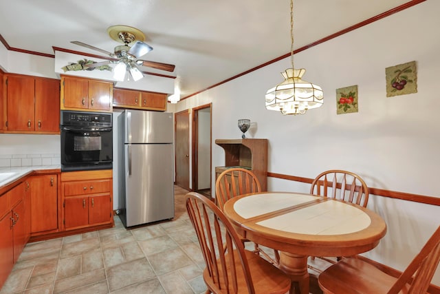2639 Halleck Dr, Columbus, OH 43209 - kitchen featuring freestanding refrigerator, oven, ornamental molding, ceiling fan, and brown cabinets