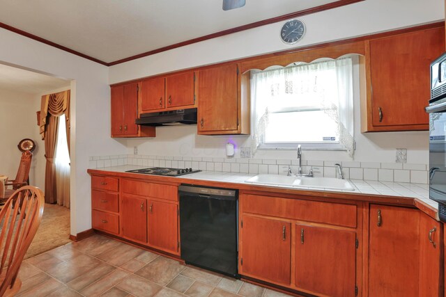 2639 Halleck Dr, Columbus, OH 43209 - kitchen with black appliances, a sink, under cabinet range hood, tile countertops, and crown molding