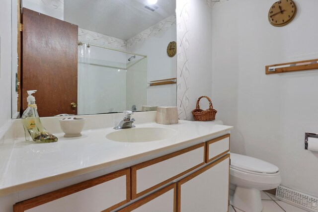2639 Halleck Dr, Columbus, OH 43209 - full bathroom featuring tile patterned floors, toilet, vanity, and a shower