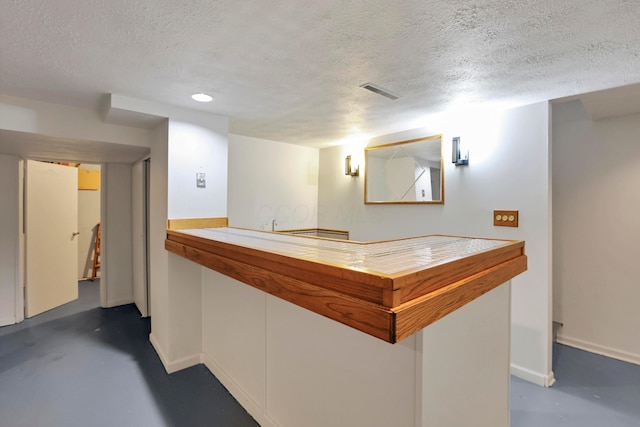 2639 Halleck Dr, Columbus, OH 43209 - bar area with a textured ceiling, finished concrete floors, and baseboards
