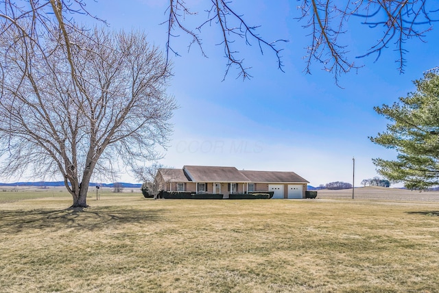 view of front of home featuring an attached garage and a front yard