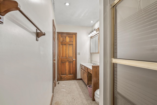 bathroom with recessed lighting, toilet, vanity, and baseboards