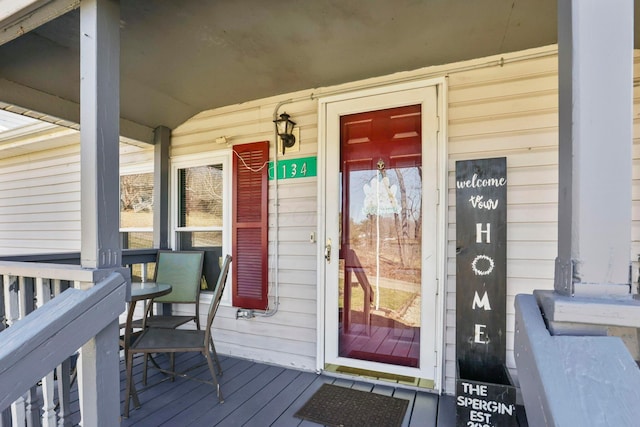 view of exterior entry with covered porch