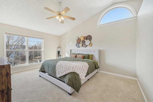 carpeted bedroom with vaulted ceiling, multiple windows, baseboards, and a textured ceiling