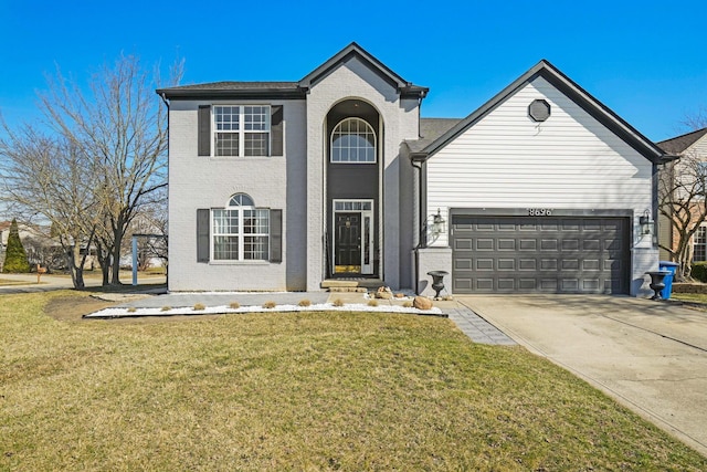 traditional-style house with brick siding, a garage, concrete driveway, and a front lawn